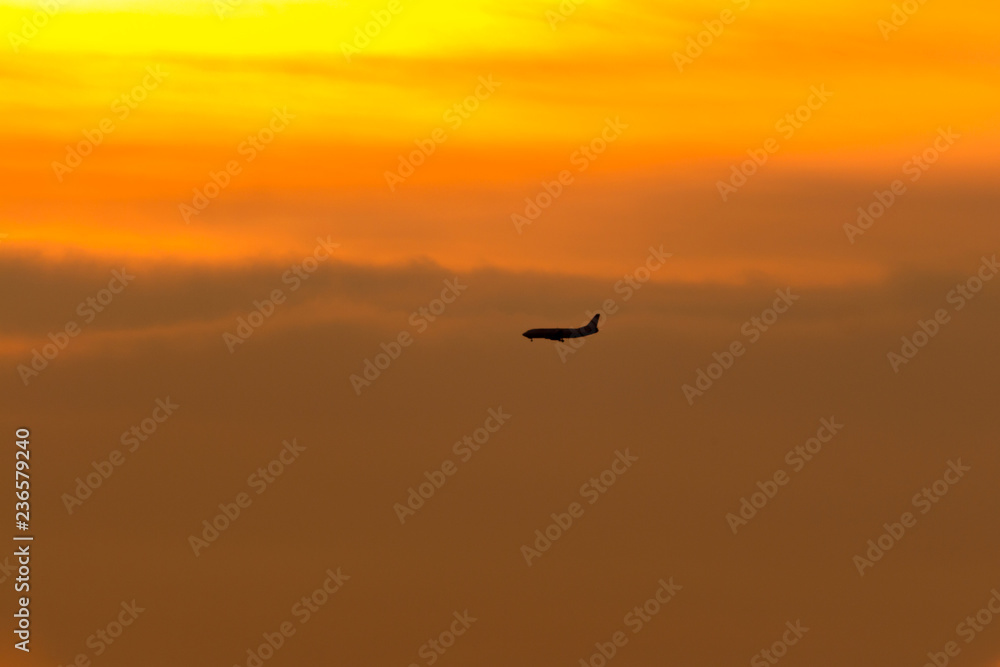 silhouette of a plane at sunset