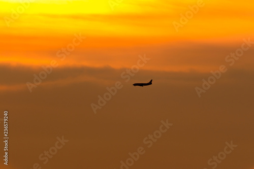 silhouette of a plane at sunset