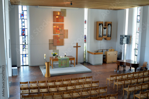 Paul-Gerhardt-Kirche in Plochingen with interior (nave), altar, crucifix and  artistic formed windows