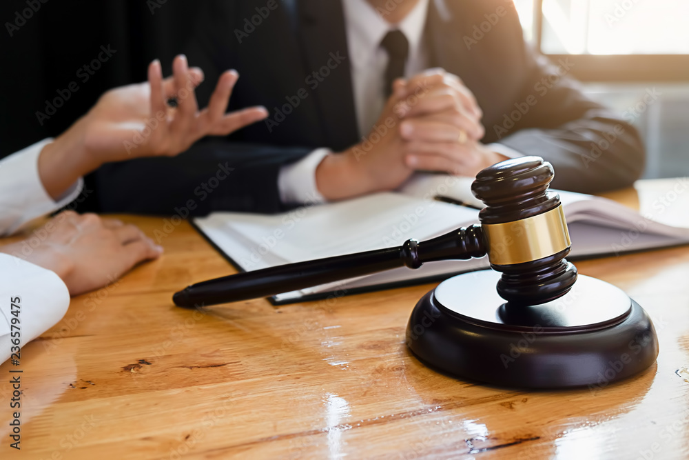 Judge gavel with Justice lawyers having team meeting at law firm background. Concepts of Law and Legal services. Judge gavel with Justice lawyers having team meeting at law firm background. Concepts of Law and Legal services.