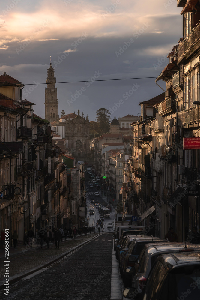 street of porto in portugal after a storm with sun shine church