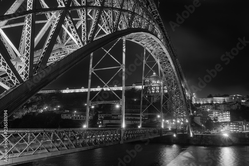 view of the bridge dom luis at night in porto city of portugal in black and white