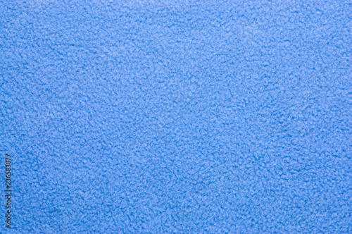 Closeup of blue plush or wool texture useful as background