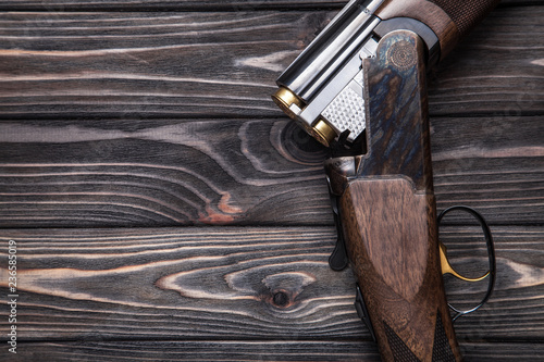 open hunting rifle on a wooden background