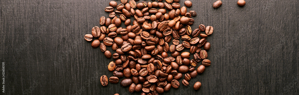 Naklejka premium coffee beans in shape of heart on wooden background