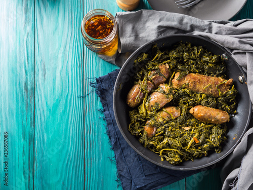 Italian sausages with rapini broccoli in a skillet photo