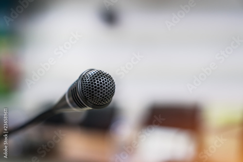 Mini Microphone on abstract blurred conference hall for speaker on stage in seminar room background, Business meeting and education in teaching classroom concept