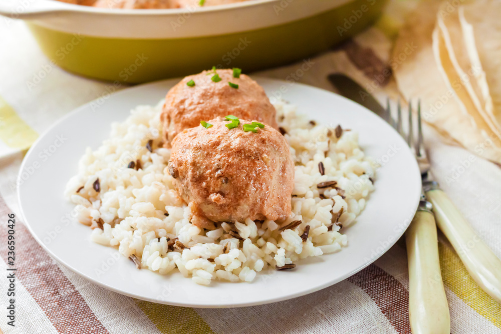 Chicken meatballs in creamy tomato sauce with rice Chicken meatballs in creamy tomato sauce with rice