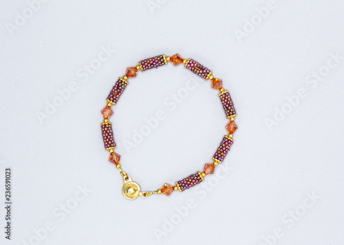 multi colored and variously sized beads bracelet on gray background