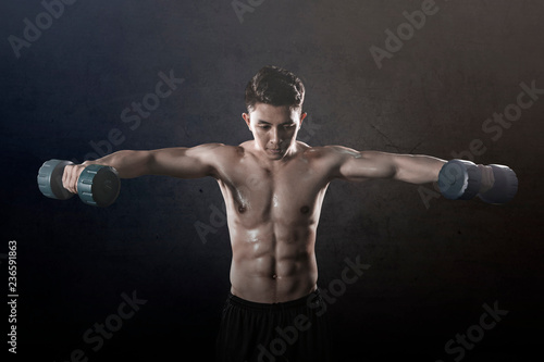 Asian man doing exercises with two dumbbells