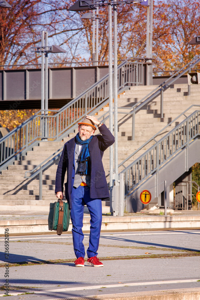 man in his 50s waiting at train station