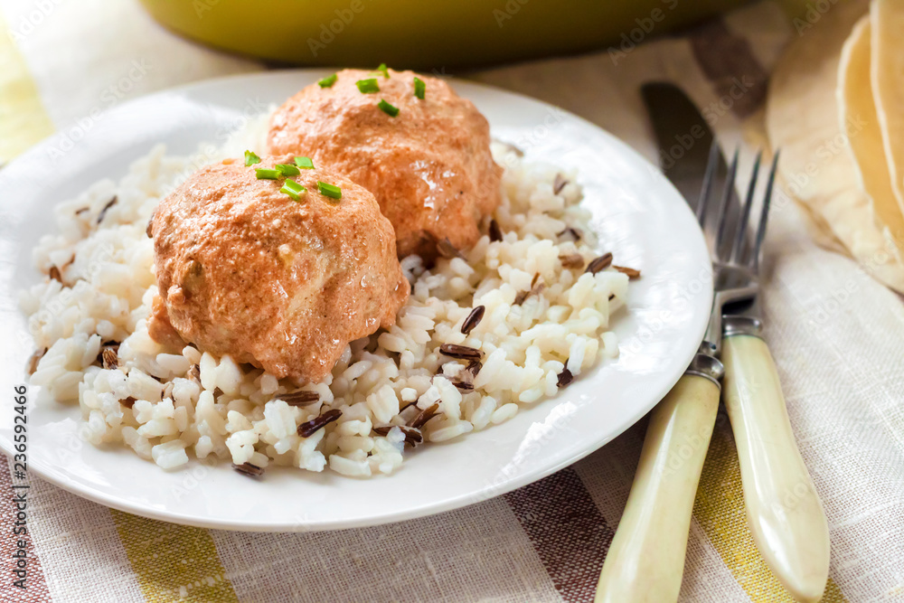 Chicken meatballs in creamy tomato sauce with rice Chicken meatballs in creamy tomato sauce with rice