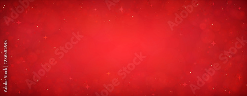 Red christmas glitter background with stars. Festive glowing blurred texture.