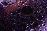 water drops on glass with colorful background, close-up 