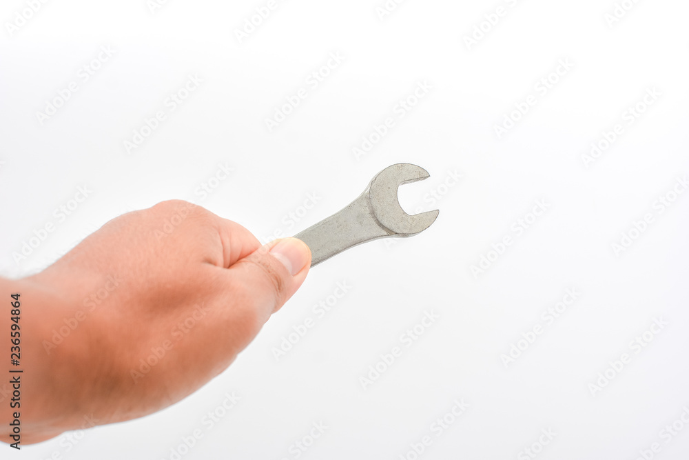 Man hand holding wrench tool , isolated on white background. Can use for fix at home by your self concept. Copy space for text or objects. Man hand holding wrench tool , isolated on white background. Can use for fix at home by your self concept. Copy space for text or objects.