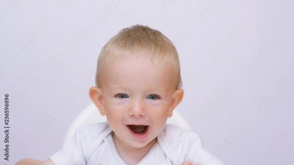 Happy baby moving playing, blue eyes child moving hands, healthy kid Happy baby moving playing, blue eyes child moving hands, healthy kid