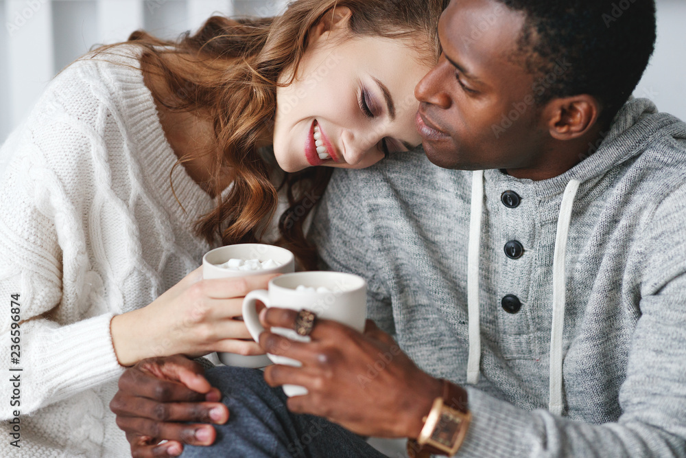 happy loving couple drinking cocoa on winter morning in bed happy loving couple drinking cocoa on winter morning in bed