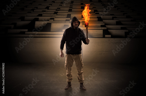 Canvas Print Ugly, aberrant man coming out from the labyrinth with burning flambeau on his ha