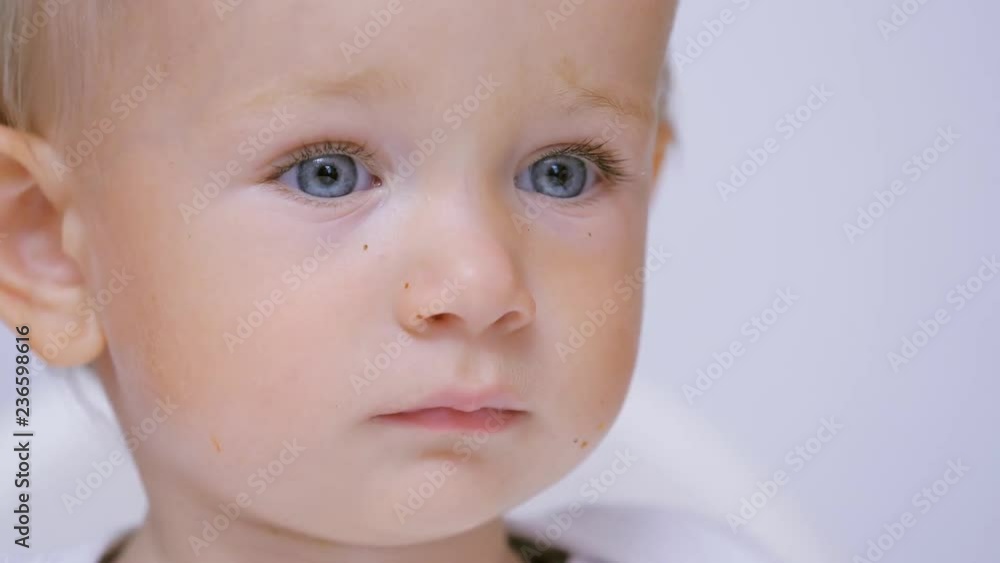 Innocent blue eyes look, close up blond hair baby portrait, purity Innocent blue eyes look, close up blond hair baby portrait, purity