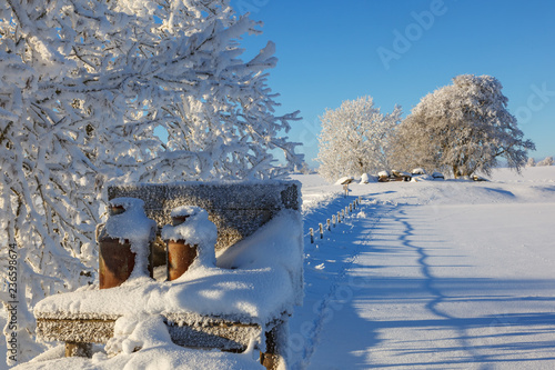 Milk churn stand in a beautiful snowy winter landscape