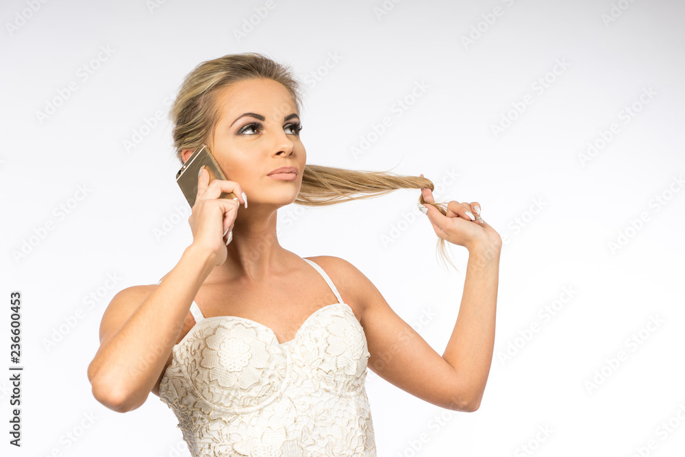 Young woman in white blouse. Blonde girl is talking on the cell phone. Female with telephone. Businesswoman calls with smartphone. Beauty portrait of modern fashion. Business look Young woman in white blouse. Blonde girl is talking on the cell phone. Female with telephone. Businesswoman calls with smartphone. Beauty portrait of modern fashion. Business look