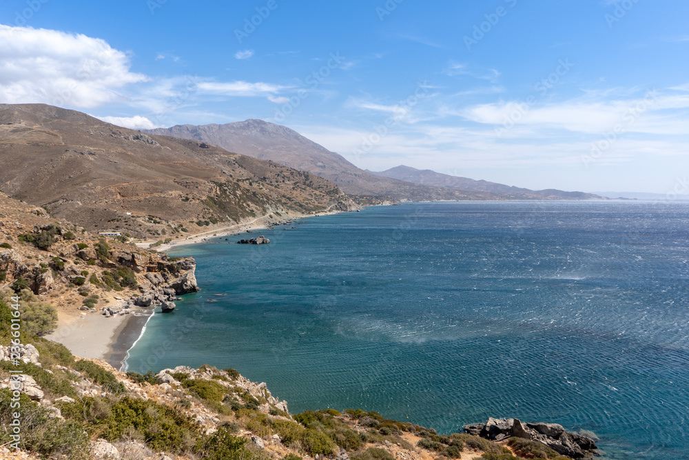 Landscape on the island of Crete, Greece with a wide view over the mountains with a bay and a beach in the front