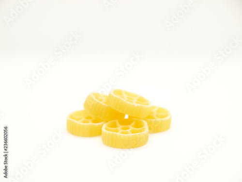 Raw round pasta on white background