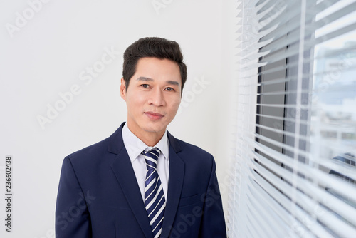 successful businessman on the background of a bright office.