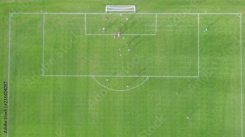 Goal - Top down aerial footage of a team scoring a goal from a free kick at an amateur soccer match.