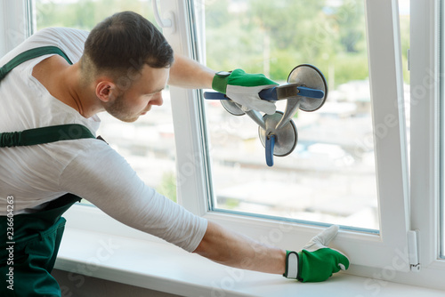 Young worker is repairing window photo