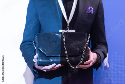 young businessman holding leather bag