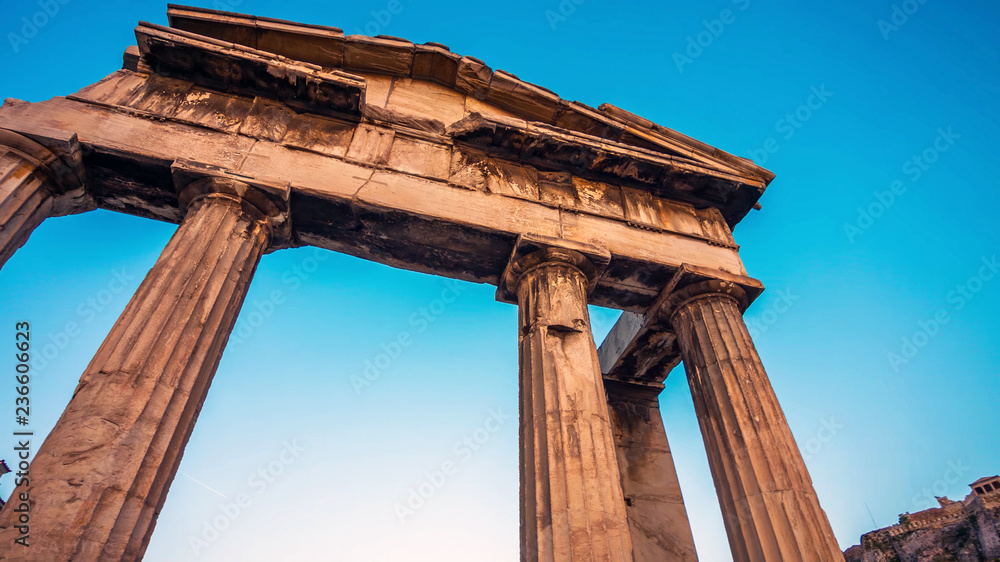 Ancient Greek temple columns against blue sky, low angle view background. Greece