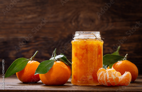 glass jar of tangerine jam with fresh fruits