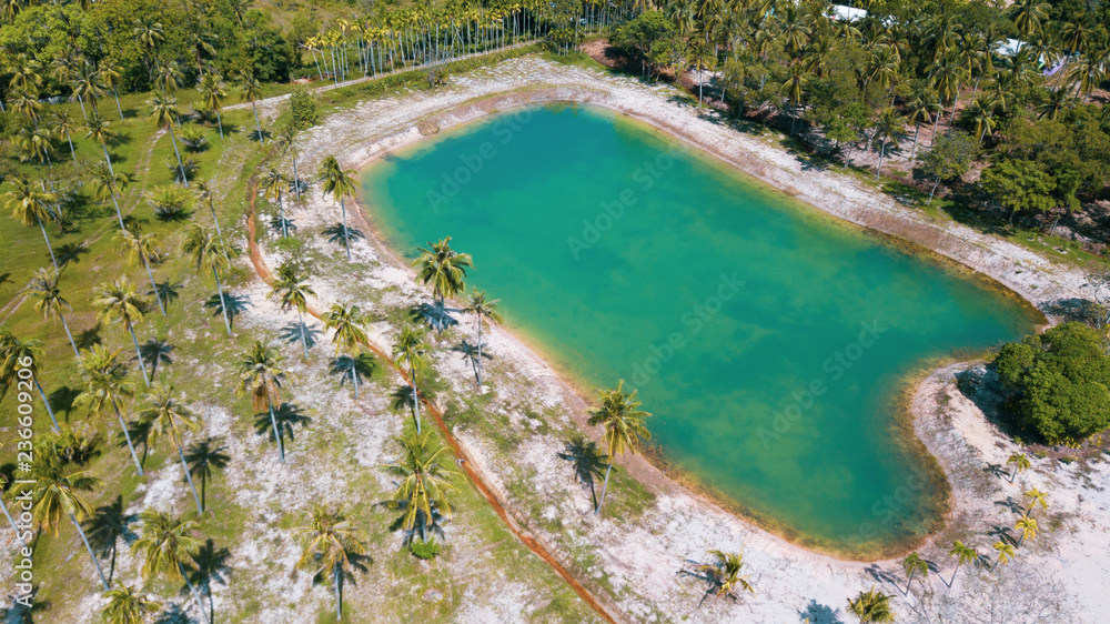 Aerial drone view of beautiful lagoon pond on tropical island during sunny summer day