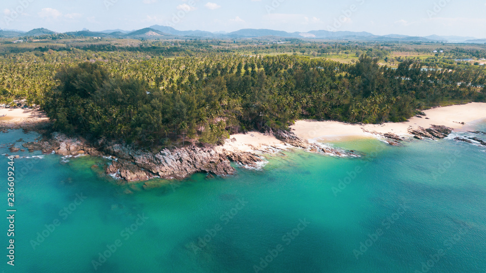 Aerial drone view of beautiful tropical island with sandy beach and green mountains. Summer and travel vacation concept