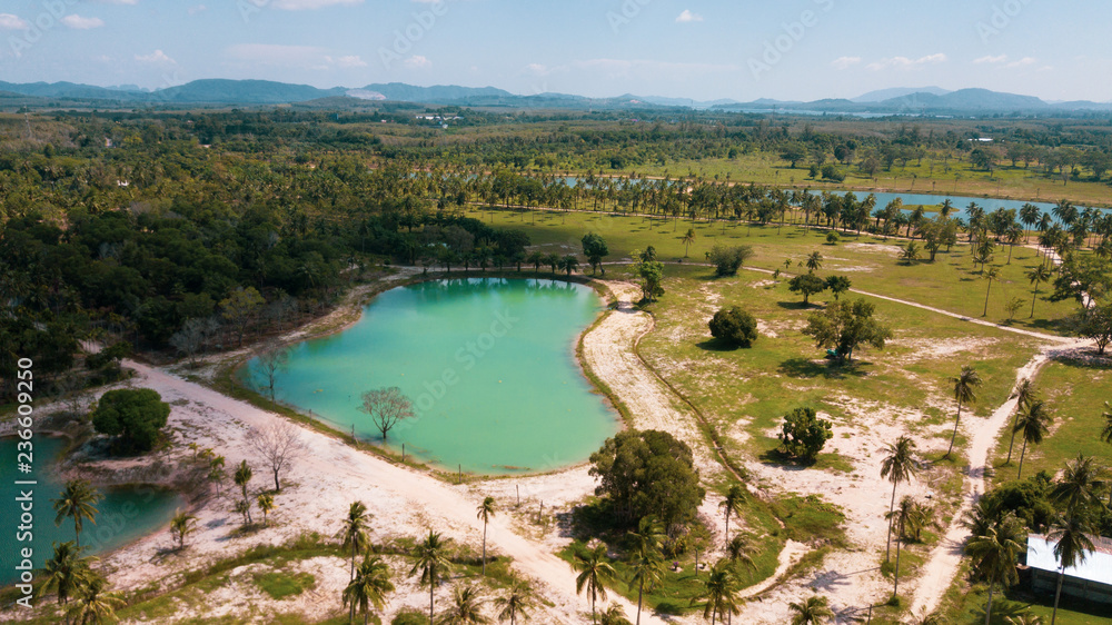 Aerial drone view of beautiful lagoon ponds on tropical island during sunny summer day