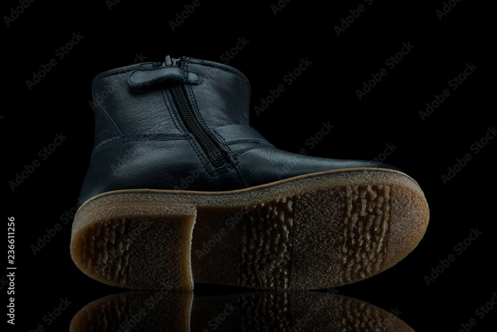 Leather boots on black background with reflection Leather boots on black background with reflection