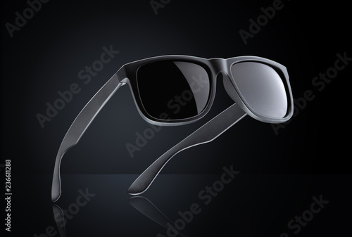 Sunglasses on black background with reflection