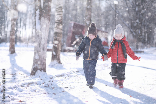 Kids walk in the park first snow © alexkich
