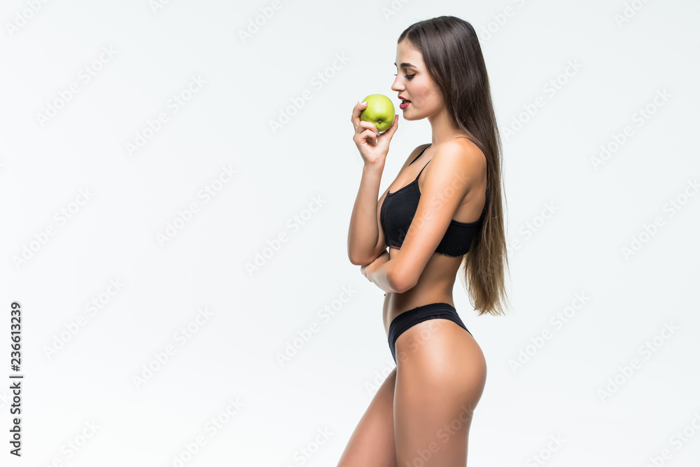 Closeup beautiful body woman sexy slim holding green apple with for wellness. Girl waist thin with fitness for weight loss and healthy isolated on white background, healthcare and diet concept. Closeup beautiful body woman sexy slim holding green apple with for wellness. Girl waist thin with fitness for weight loss and healthy isolated on white background, healthcare and diet concept.