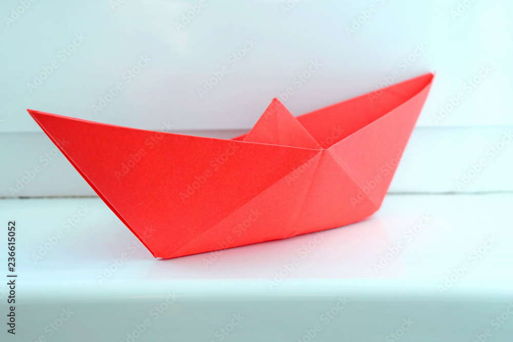 red paper boat on a light background red paper boat on a light background