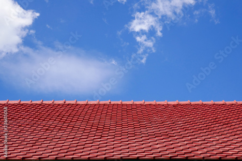 Red roof tile in Thai style with blue sky on a sunny day