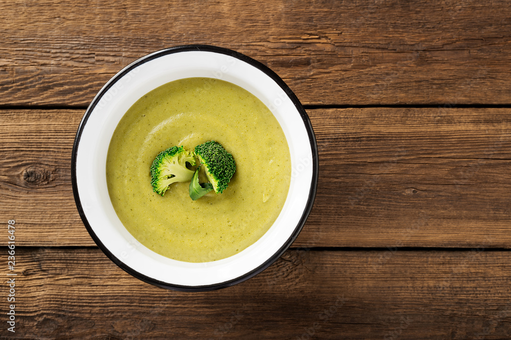 Fresh broccoli cream soup in bowl. Top view Fresh broccoli cream soup in bowl. Top view