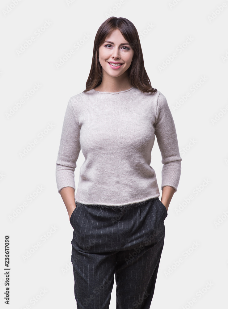 Beautiful young woman portrait. Smiling cute girl with long hair studio shot. Isolated on gray background Beautiful young woman portrait. Smiling cute girl with long hair studio shot. Isolated on gray background