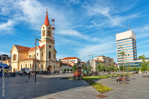 Zrenjanin, Serbia - May 17, 2018: Zrenjanin downtown, city architecture, urban landscape. Square of freedom with Cathedral of St. John of Nepomuk and a monument of King Petar Karadjordjevic the first.