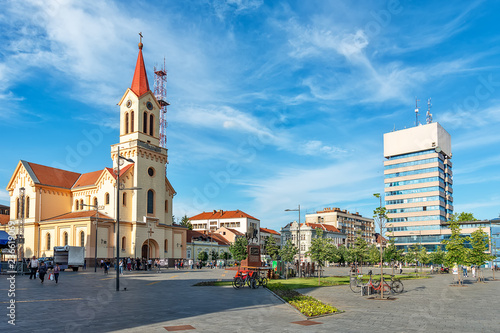Zrenjanin, Serbia - May 17, 2018: Zrenjanin downtown, city architecture, urban landscape. Square of freedom with Cathedral of St. John of Nepomuk and a monument of King Petar Karadjordjevic the first.
