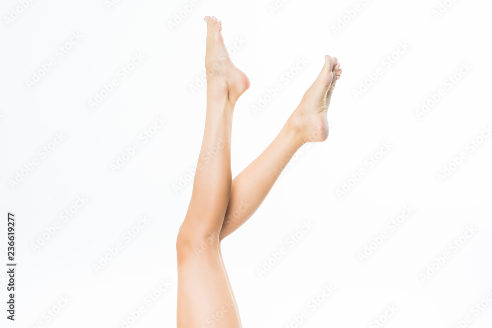 Healthy slender female legs isolated on white background Healthy slender female legs isolated on white background