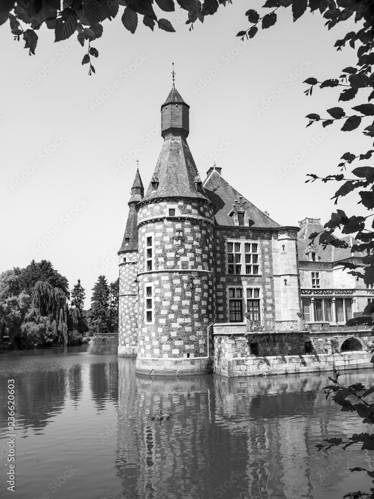 The beautiful tower of Jehay Castle or Jehay-Bodegnee Castle - a water castle in Province of Liege, Belgium, black and white photography The beautiful tower of Jehay Castle or Jehay-Bodegnee Castle - a water castle in Province of Liege, Belgium, black and white photography