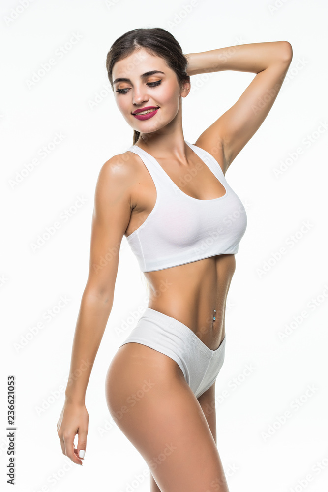 Perfect slim toned young body of the girl or fit woman isolated on white  background. The fitness, diet, sports, plastic surgery and aesthetic  cosmetology concept. Stock Photo