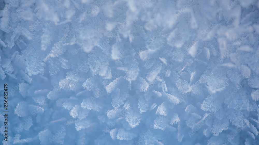 Macro look of snowflakes, snow crystals. Abstract winter background, banner Macro look of snowflakes, snow crystals. Abstract winter background, banner